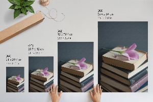 Wall art featuring a floral motif with books