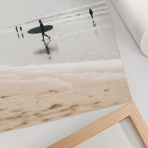 Wall art depicting surfers on the beach