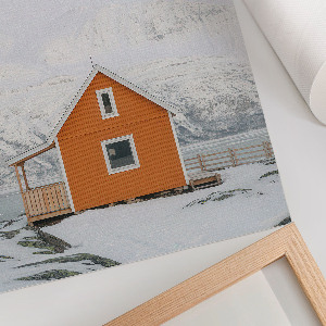 Wall art depicting a mountain cottage