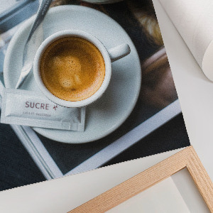Wall print featuring a cup of coffee and a croissant