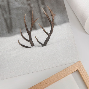 Wall art featuring antlers in the snow