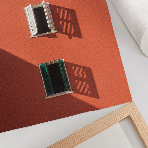 Wall art featuring an orange building facade